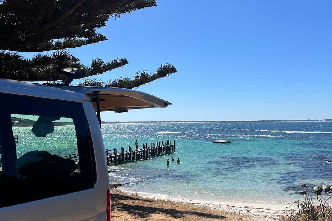 Back of van looking out over secluded beach
