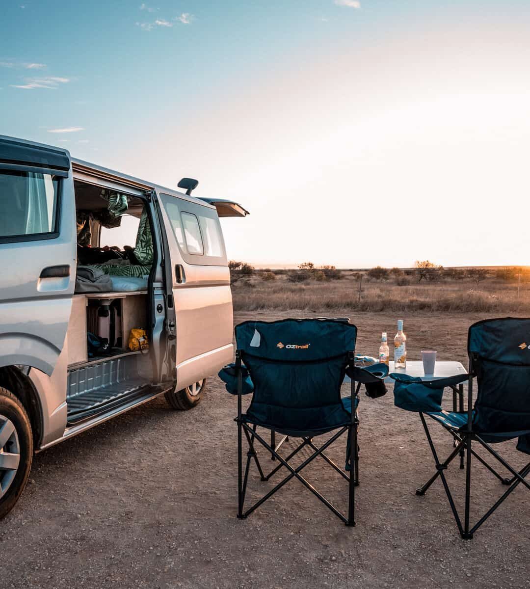 Home On The Road Campervan Hire with camping chairs set up in outback location