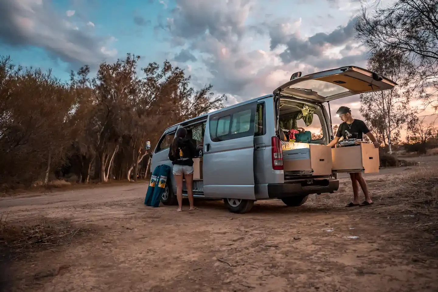 Couple setting up their campervan at campsites near perth