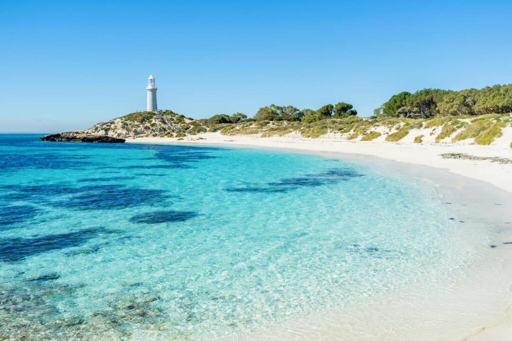 Pinky's Beach on Rottnest Island with it's white sand, turquoise water and small white lighthouse