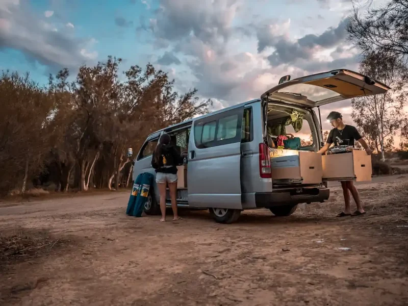 Couple setting up their campervan at campsites near perth
